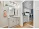 Modern bathroom features a vanity with a mirror, sink, and access to laundry area with a washer and dryer at 6045 Haverford Ave, Indianapolis, IN 46220