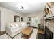 Comfortable living room featuring a sofa, fireplace, and ample natural light at 6045 Haverford Ave, Indianapolis, IN 46220