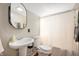 Small bathroom with a pedestal sink, toilet, and shower/tub combination at 6640 E Washington St, Indianapolis, IN 46219