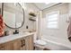 Updated bathroom featuring a vanity sink, toilet, and shower/tub combination at 6640 E Washington St, Indianapolis, IN 46219