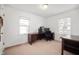 Simple bedroom featuring two windows and a work desk and chair at 6640 E Washington St, Indianapolis, IN 46219