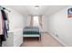 Bright bedroom with a window, light-colored carpet, and white furniture at 6640 E Washington St, Indianapolis, IN 46219