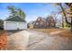 Charming brick two-story home with detached two-car garage and mature trees at 6640 E Washington St, Indianapolis, IN 46219