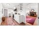 Modern white kitchen featuring updated stainless steel appliances and plenty of countertop space at 6640 E Washington St, Indianapolis, IN 46219