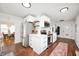 Contemporary kitchen with white cabinetry, stainless appliances, and adjoining dining area at 6640 E Washington St, Indianapolis, IN 46219