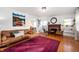 Inviting living room with a comfortable sofa, decorative fireplace, and warm hardwood floors at 6640 E Washington St, Indianapolis, IN 46219