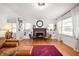 Spacious living room with hardwood floors, a fireplace, and large windows offering natural light at 6640 E Washington St, Indianapolis, IN 46219