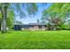 Expansive backyard view featuring a well-maintained lawn and home's deck, perfect for outdoor activities at 6704 Hoover Rd, Indianapolis, IN 46260