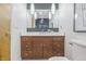 Modern bathroom features wood vanity with chrome hardware, white countertop, and stylish lighting at 6704 Hoover Rd, Indianapolis, IN 46260