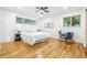 Bright, spacious bedroom featuring hardwood floors, ample natural light, and neutral decor at 6704 Hoover Rd, Indianapolis, IN 46260