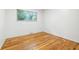 Bedroom with hardwood flooring and a window providing natural light at 6704 Hoover Rd, Indianapolis, IN 46260