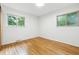 Bedroom showcasing two windows providing natural light and gleaming hardwood floors at 6704 Hoover Rd, Indianapolis, IN 46260