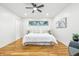 Bright bedroom featuring hardwood floors, ample natural light, and neutral decor at 6704 Hoover Rd, Indianapolis, IN 46260