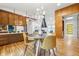 Bright dining area with modern lighting, wood floors, and an open floor plan at 6704 Hoover Rd, Indianapolis, IN 46260