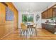 Cozy dining area with natural wood paneling and stylish chandelier, seamlessly connected to the kitchen for easy meal service at 6704 Hoover Rd, Indianapolis, IN 46260