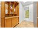 Inviting hallway with wood floors, built-in shelves, and a striking yellow door at 6704 Hoover Rd, Indianapolis, IN 46260