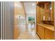 Hallway with wood paneling and storage leading into the dining area at 6704 Hoover Rd, Indianapolis, IN 46260