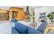 Open-concept living room featuring a cone fireplace, built-in wood shelving, and an adjacent dining area for seamless entertaining at 6704 Hoover Rd, Indianapolis, IN 46260