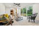 Well-lit living room with large windows and modern furnishings, including a stylish accent chair at 6704 Hoover Rd, Indianapolis, IN 46260