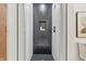 Modern shower stall featuring white and black tiles and a built-in niche for storage at 6704 Hoover Rd, Indianapolis, IN 46260
