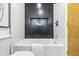 Bathtub with tile surround and a built-in niche for storage in a modern bathroom design at 6704 Hoover Rd, Indianapolis, IN 46260