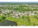 Aerial neighborhood view featuring lush greenery, a tranquil pond, and well-maintained homes under a clear sky at 7456 Jack Pine Ct, Avon, IN 46123