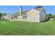 Home's backyard featuring a well-maintained lawn, siding, and sliding glass door at 7456 Jack Pine Ct, Avon, IN 46123