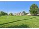 Spacious backyard with a well-maintained lawn and a view of the home's exterior at 7456 Jack Pine Ct, Avon, IN 46123