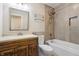 Modern bathroom featuring a wood vanity, tiled walls, and shower-tub combo at 7456 Jack Pine Ct, Avon, IN 46123