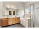 Spacious bathroom with double vanity, large mirror, tub, and separate shower at 7456 Jack Pine Ct, Avon, IN 46123