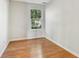 Bright bedroom featuring gleaming hardwood floors and a sunlit window view at 7456 Jack Pine Ct, Avon, IN 46123
