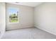 Empty bedroom with neutral carpet and a sunlit backyard view at 7456 Jack Pine Ct, Avon, IN 46123