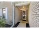 Welcoming brick porch with a dark wood door and decorative outdoor lighting at 7456 Jack Pine Ct, Avon, IN 46123