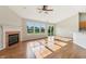 Bright living room featuring a fireplace, ceiling fan, and sliding door access to outdoor space at 7456 Jack Pine Ct, Avon, IN 46123