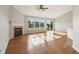 Spacious living area with a fireplace, ceiling fan and large windows overlooking backyard at 7456 Jack Pine Ct, Avon, IN 46123