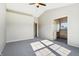 Main bedroom featuring ceiling fan, neutral carpet, and a bathroom view at 7456 Jack Pine Ct, Avon, IN 46123