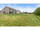 Large backyard featuring a covered patio, lush lawn, and a playset at 7603 Merrick Dr, Brownsburg, IN 46112