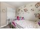 This bedroom features unique floral wall accents, a bed with plush blankets, and a closet at 7603 Merrick Dr, Brownsburg, IN 46112