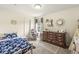 Charming bedroom with a rocking chair, patterned rug, and ample natural light at 7603 Merrick Dr, Brownsburg, IN 46112