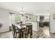 Dining room with dark wood table, chandelier, and view into kitchen at 7603 Merrick Dr, Brownsburg, IN 46112