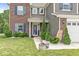 Inviting front porch with decorative plants, white gravel, and a charming 'Hello Sunshine' sign at 7603 Merrick Dr, Brownsburg, IN 46112