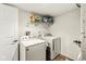 Practical laundry room equipped with a washer, dryer, and shelving for storage solutions at 7603 Merrick Dr, Brownsburg, IN 46112