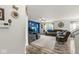 Open-concept living room featuring blue accent wall, plush furniture, and wood-look flooring at 7603 Merrick Dr, Brownsburg, IN 46112