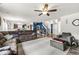 Bright open floor plan with wood-look floors, blue accent wall, and comfortable furniture at 7603 Merrick Dr, Brownsburg, IN 46112