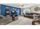 Comfortable living room with blue accent wall, plush seating, and a ceiling fan at 7603 Merrick Dr, Brownsburg, IN 46112