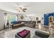 Spacious living room with an open floor plan, ceiling fan, and wood-look flooring at 7603 Merrick Dr, Brownsburg, IN 46112