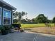 Backyard featuring a concrete patio, lush lawn, mature trees, and a storage container at 7870 E County Road 150 S, Avon, IN 46123