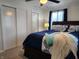 Bedroom features a ceiling fan, two closets, and a queen-size bed with blue bedding at 7870 E County Road 150 S, Avon, IN 46123