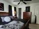 Bedroom featuring a wood bed frame, ceiling fan, neutral walls, and an ensuite door at 7870 E County Road 150 S, Avon, IN 46123