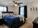 Bedroom features a ceiling fan, blue curtains, and a queen-size bed with blue bedding at 7870 E County Road 150 S, Avon, IN 46123